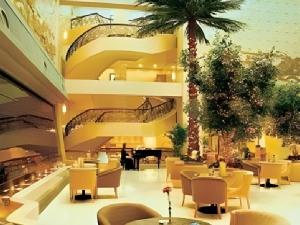 a restaurant with a spiral staircase in a building at Fujian Hotel in Beijing