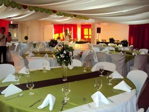 a banquet hall with white tables and white chairs at My Hotel Davao in Davao City