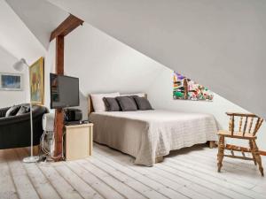 a bedroom with a bed and a tv in it at 5 star holiday home in Hasselager in Hørning +13 photos