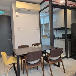 a dining room table and chairs in a kitchen at 3 Tower Ampang Suite in Kuala Lumpur