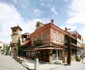 an old building with a clock tower on top of it at Tbilisi Art Apartment in Tbilisi City