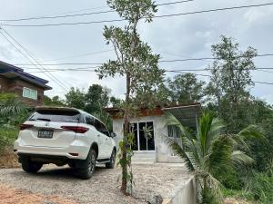 a white car parked in front of a house at Villa Krabi Center in Ban Nong Chaeng