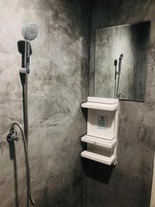 a shower in a bathroom with a sink and a mirror at Villa Krabi Center in Ban Nong Chaeng