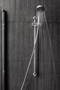 
a shower with a hose attached to it at Hostal Boutique Khronos in Barcelona
