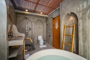 a bathroom with a shower and a bath tub at Stone Ridge Kintamani in Kintamani +52 photos