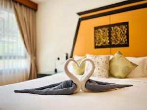 two swans making a heart on a bed at Laguna Village by RESAVA in Layan Beach