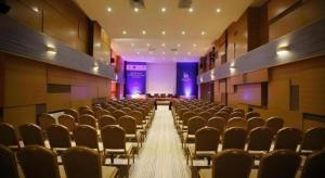 a room with rows of chairs and a stage at The Corporate Hotel and Convention Centre in Ulaanbaatar +213 photos