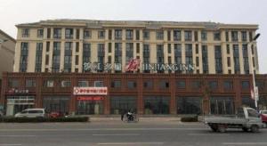 a large building with a sign on top of it at Jinjiang Inn Tianjin Jizhou Renmin West Street Branch in Jizhou