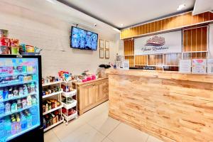 a fast food restaurant with a counter and a refrigerator at RedDoorz at Vania Residence Medan in Medan +25 photos