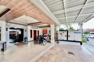 a garage with a motorcycle parked inside of it at RedDoorz at Vania Residence Medan in Medan