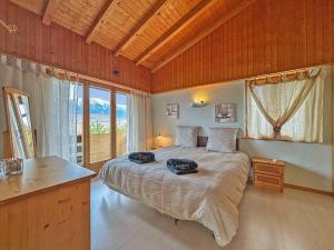 a bedroom with a large bed with a large window at Alpine Balance - Sion and ski stay - Swiss Alp in Salins
