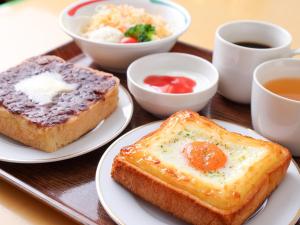 a tray with two plates of food with eggs and toast at APA Hotel Sendai Kotodai Koen in Sendai