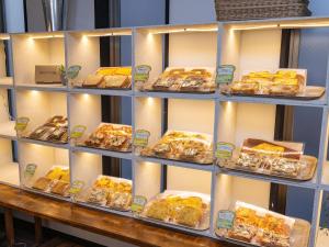 a shelf filled with different types of pastries at APA Hotel Sendai Kotodai Koen in Sendai