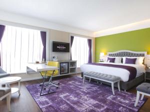 a bedroom with a large bed with a purple rug at Mercure Tbilisi Old Town in Tbilisi City