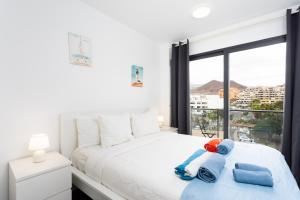 a bedroom with a bed with two stuffed animals on it at New apartment center Los Cristianos in Los Cristianos