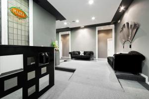 a lobby with couches and a tv in a building at Hostal Boutique Khronos in Barcelona