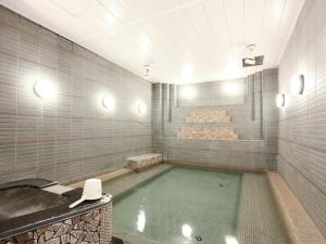 a bathroom with a bath tub with a sink and a bath tub at Refre Forum in Tokyo