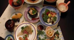 a table with plates of food and bowls of food at Hotel Kaanapali in Shirako
