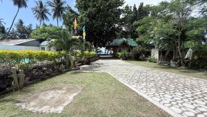 a cobblestone path in front of a house at Seaside traveler's Inn by Camiguin Island Home in Catarman