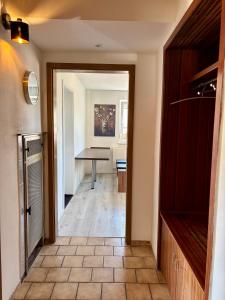 a hallway leading to a dining room with a table at Schwabenperle Apartments in Lauchheim