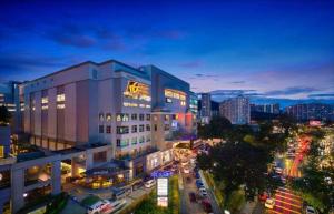 a building in a city at night with traffic at GEORGETOWN @ NEW WAVE HOTEL in George Town