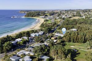 an aerial view of a beach with houses and the ocean at Surfrider 11 in Mollymook