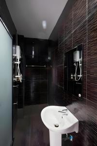 a bathroom with a white sink and a shower at X GO INN Chiang Mai University CMU - โกอินน์ เชียงใหม่ in Chiang Mai +36 photos