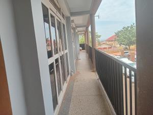a hallway of a building with a balcony at Unique suites apartments in Mukono
