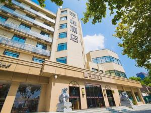 a tall building with a statue in front of it at James Joyce Coffetel· Hefei Anhui Agricultural University in Hefei