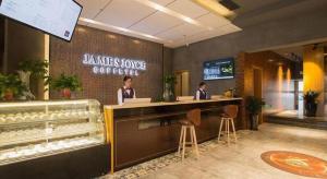 two women sitting at a counter in a restaurant at James Joyce Coffetel· Hefei Anhui Agricultural University in Hefei