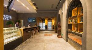 a restaurant with a bakery with a counter and people at James Joyce Coffetel· Hefei Anhui Agricultural University in Hefei
