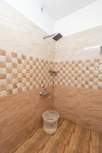 a bathroom with a faucet and a bucket at Altinho Heritage Castle Homestay in Ettumānūr