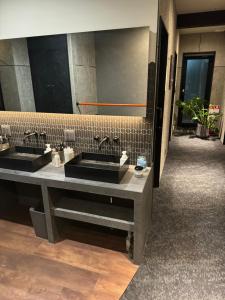 a bathroom with two sinks and a large mirror at The EKAI in Toyohashi +37 photos