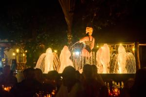 a man standing in front of a fountain at night at Dolce Vita Hotel in Puerto Princesa City +61 photos