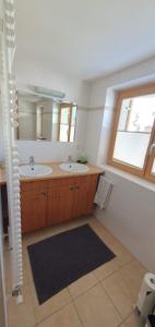 a bathroom with two sinks and a window at Haus Johanneshof 1604 in Lech am Arlberg +43 photos