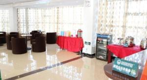 a room with red tables and chairs and a room with aperature at Shell Changzhou Yangrong City Hotel in Changzhou