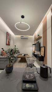 a living room with a table and a living room at Luxury 2BR Apartment -Prime Area in Jeddah
