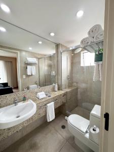 a bathroom with a sink and a toilet and a shower at Radisson Blu São Paulo in Sao Paulo +103 photos