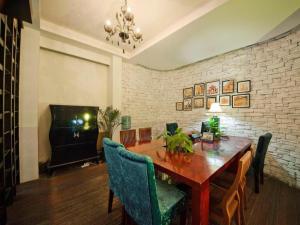a dining room with a wooden table and chairs at Guilin Sapphire hotel in Guilin