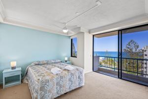 a bedroom with a bed and a view of the ocean at Burgess @ Kings Beach Apartments in Caloundra +57 photos