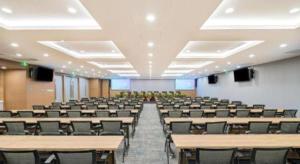 an empty lecture hall with desks and chairs at Broadcasting Tower Beijing Hotel in Beijing