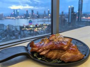 a plate of food on a table next to a window at Nanchang Oriscene Garden Hotel in Nanchang