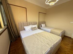 una habitación con dos camas en una habitación en Grand Royal central Cairo Home, en El Cairo