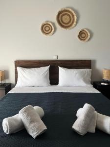 a bedroom with a bed with two towels on it at The side of Meteora majestic apartment in Kalabaka