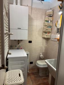 a small bathroom with a sink and a toilet at Cozy Apartment Near Lake Como, Sleeps for 4 in Maslianico +10 photos