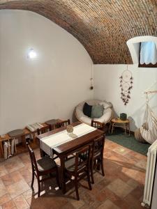 a living room with a table and chairs and a couch at Cozy Apartment Near Lake Como, Sleeps for 4 in Maslianico