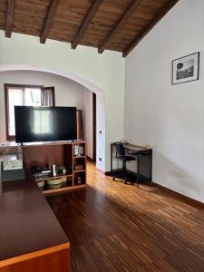 a living room with a large flat screen tv at Cozy Apartment Near Lake Como, Sleeps for 4 in Maslianico