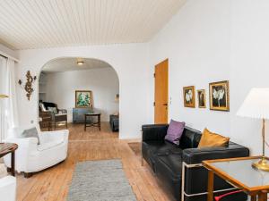 a living room with a couch and a table at 8 person holiday home in Ålbæk in Ålbæk
