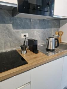 a kitchen counter with pots and pans on a stove at Alis home 100 mt dal mare in Loano