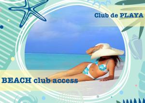 a woman in a bikini and a hat on a beach at Condo 1bdr 1bth on the beach in Punta Cana